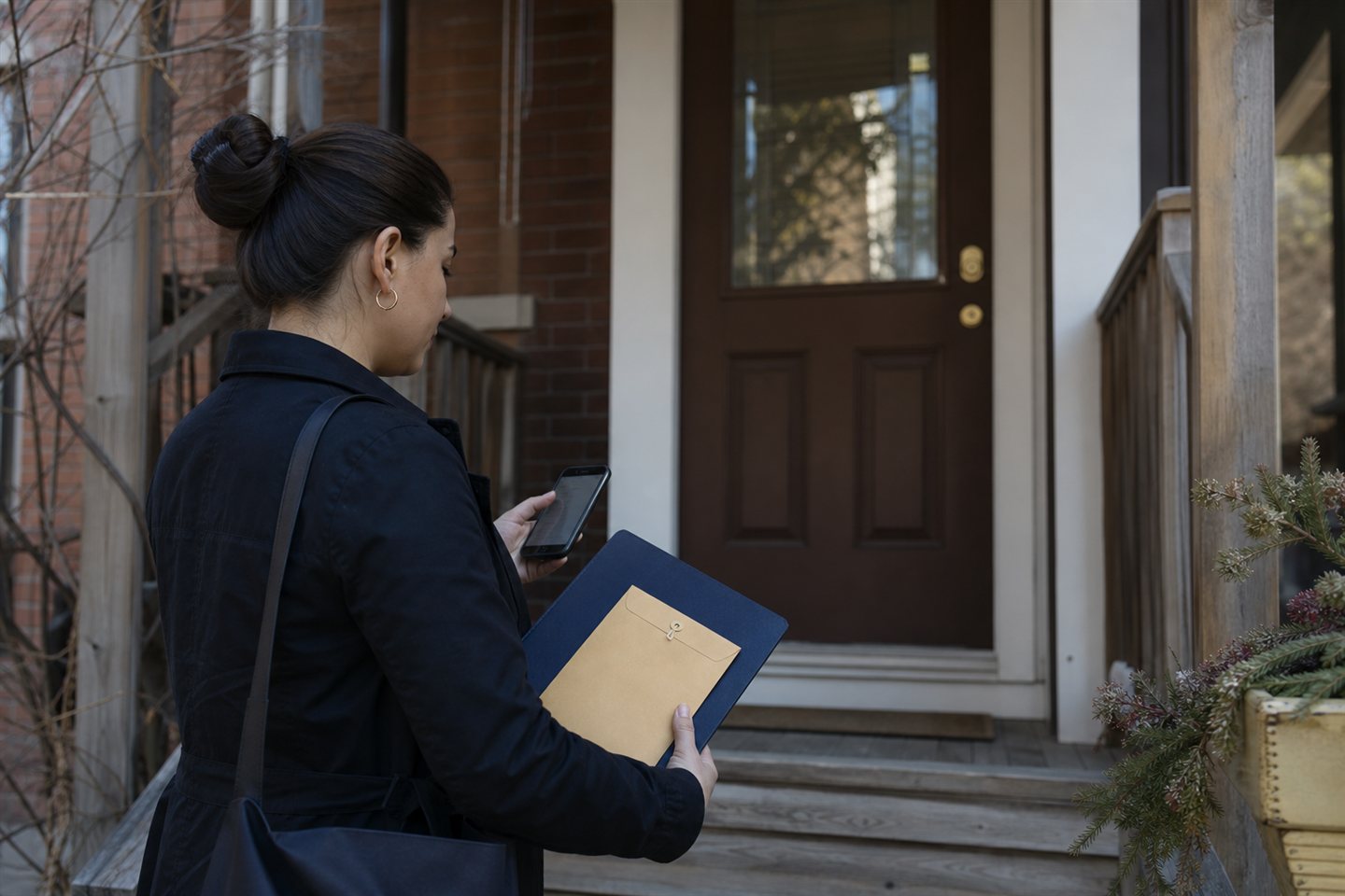 Process server documenting a residential attendance while carrying a sealed envelope